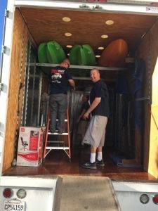 Men loading kayaks into a truck