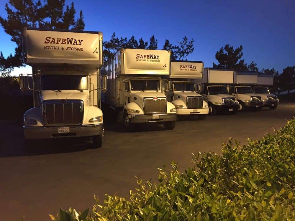 Safeway branded moving trucks at night